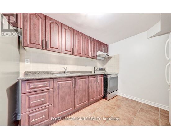 A kitchen with brown cabinets and a stainless steel dishwasher.