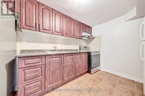 A kitchen with brown cabinets and a stainless steel dishwasher.