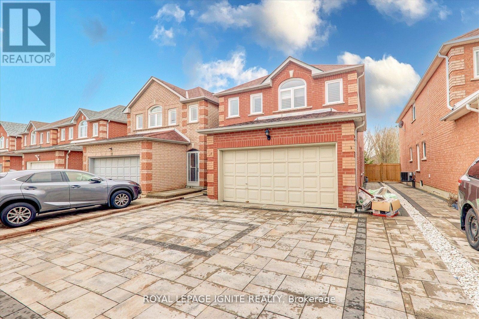 A Royal LePage real estate brokerage is advertising a property with a brick house and a garage.