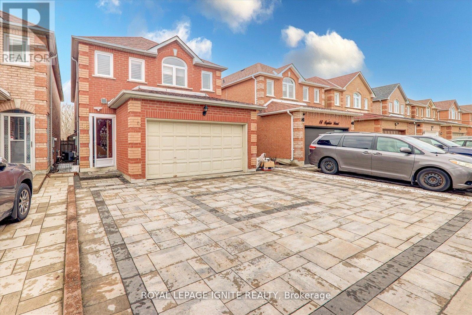 A house with a garage and a car parked in front.