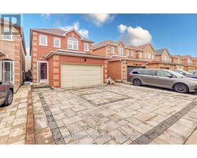 A house with a garage and a car parked in front.