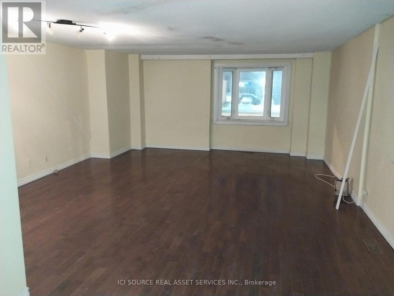 A room with wooden floors and a window.