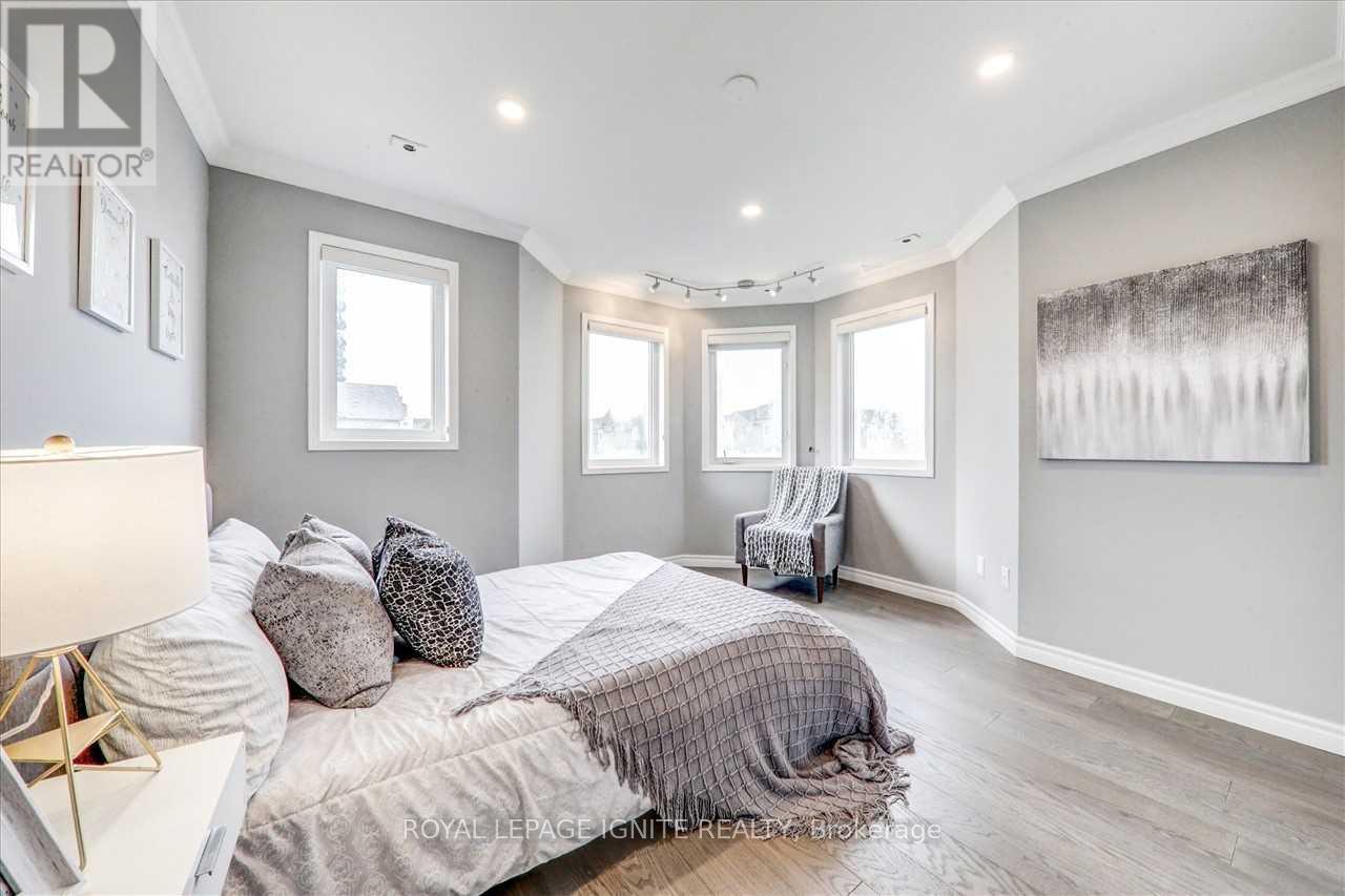 A bedroom with a large bed and a painting on the wall.