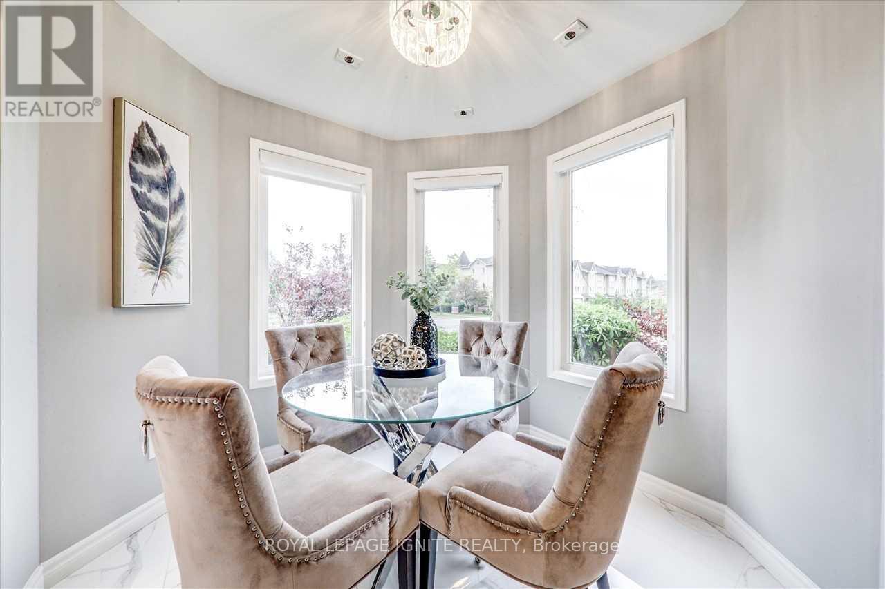 A dining room with a glass table and chairs.