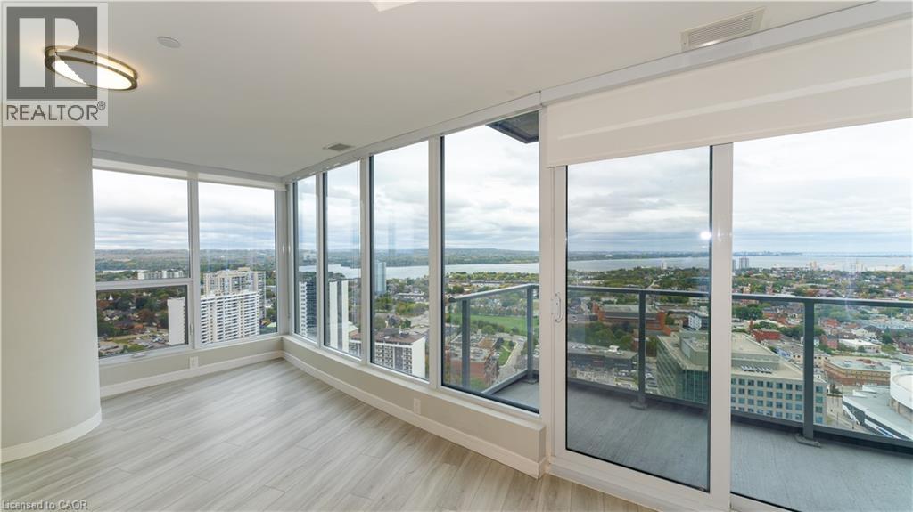 A spacious room with large windows overlooking a cityscape.