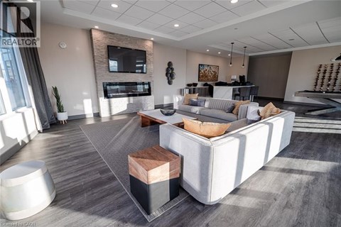 A modern living room with a grey carpet and a white sofa.