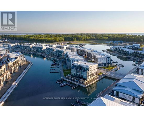 A real estate company logo is displayed on an aerial view of a waterfront property.