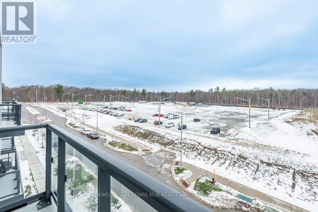 A parking lot with cars and a building in the background.