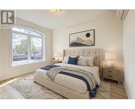 A bedroom with a large bed, a nightstand, and a window with a view of the city.