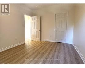 A room with two doors and a wooden floor.