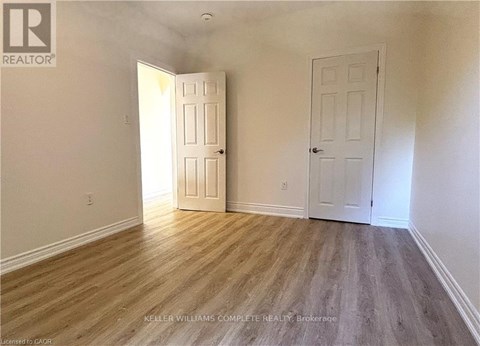 A room with two doors and a wooden floor.