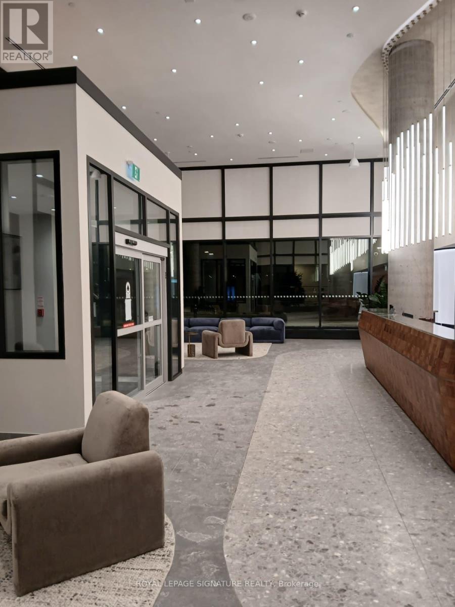 A modern waiting area with a carpeted floor and a few chairs.