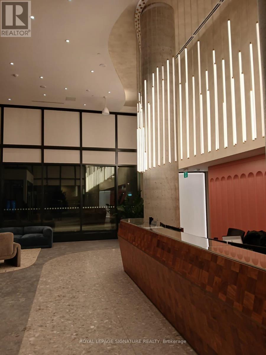 A reception area with a brown checkered wall and a white reception desk.