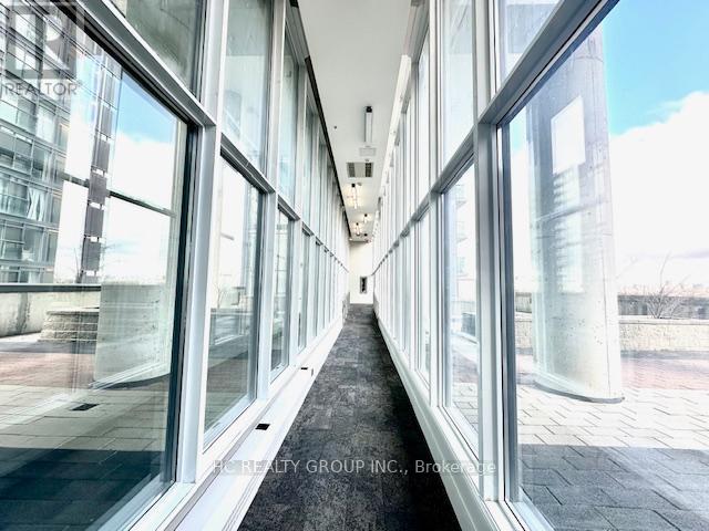 A long hallway with glass walls on both sides.