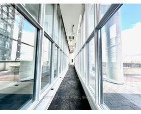 A long hallway with glass walls on both sides.