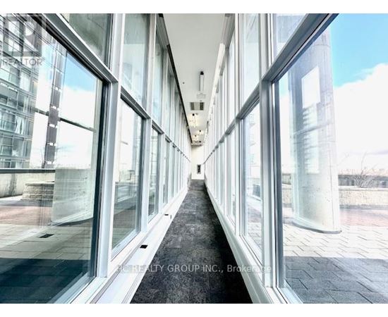 A long hallway with glass walls on both sides.