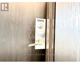 A door handle with a keypad and a number 1009E on it.
