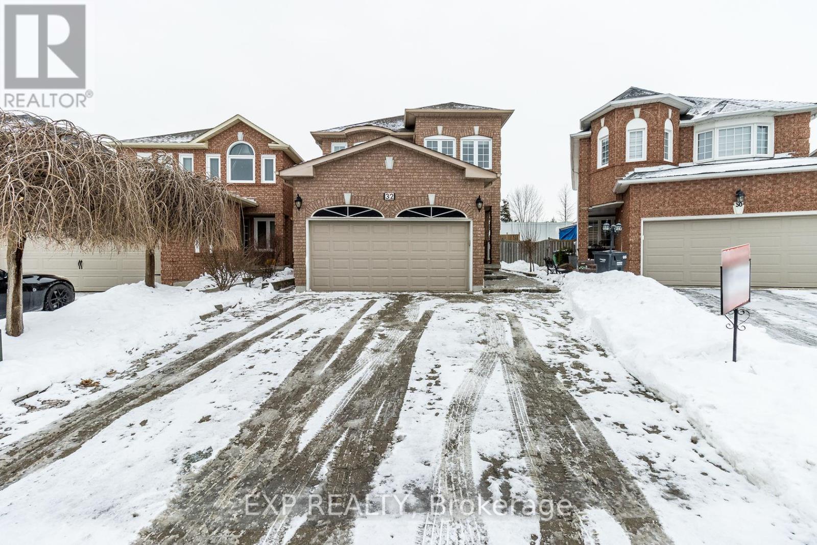 A snow-covered driveway leads to a large house with a garage.