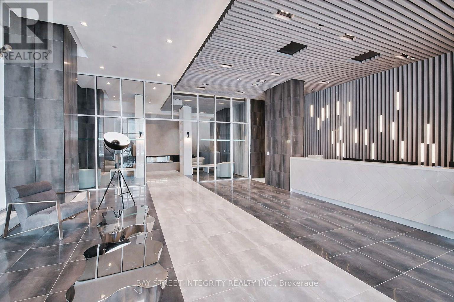 A modern interior space with a marble floor and a glass wall.