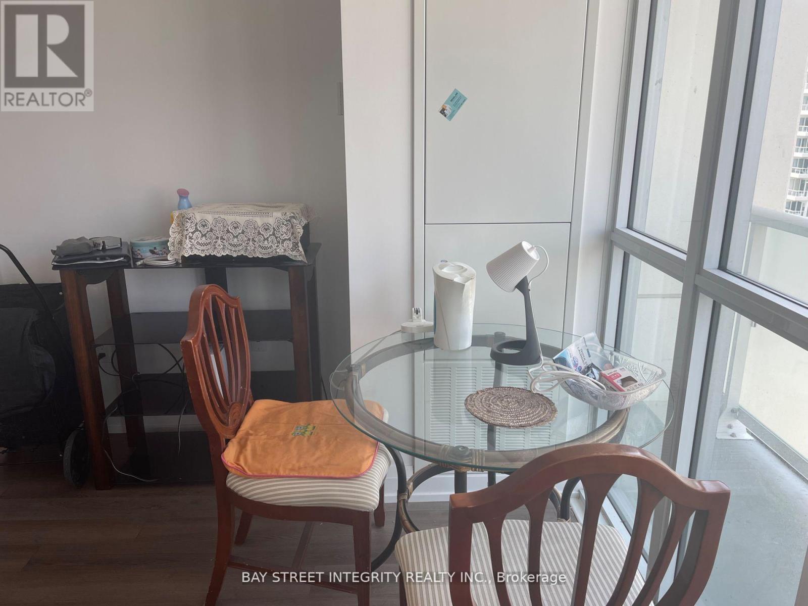 A dining room with a glass table and chairs.