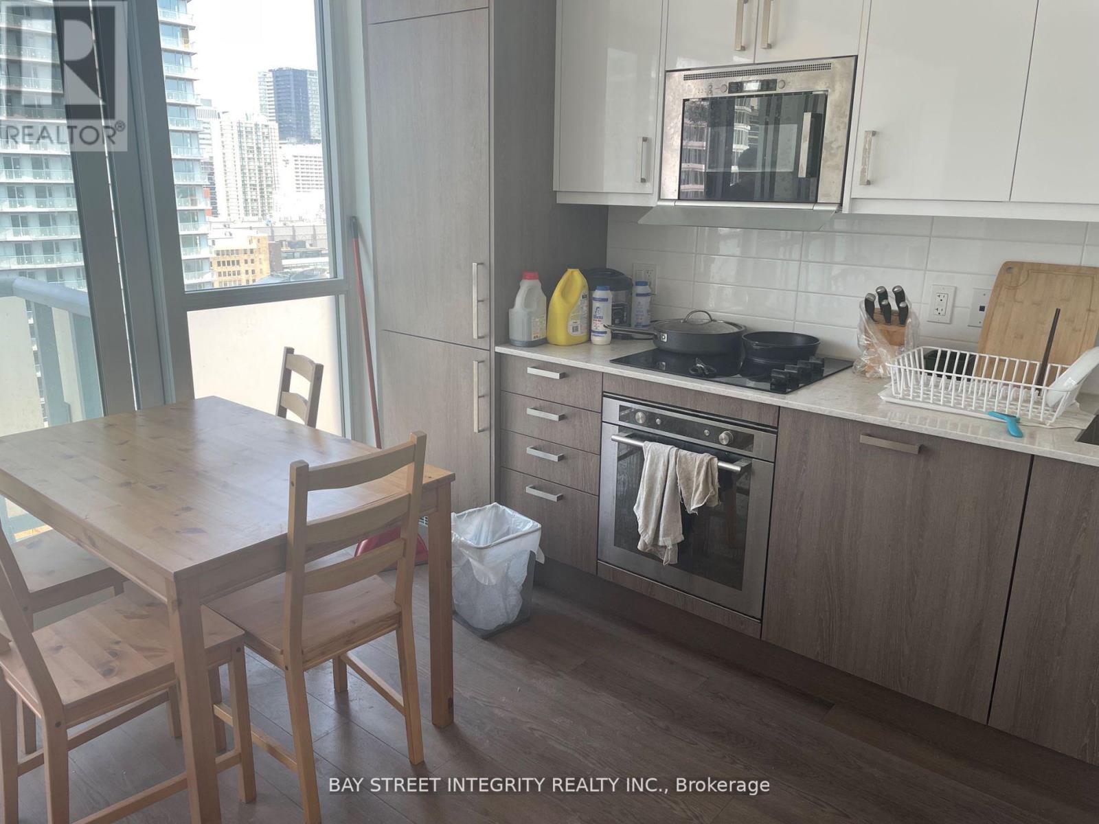 A kitchen with a table and chairs in front of a window.