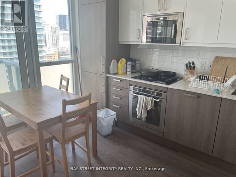 A kitchen with a table and chairs in front of a window.