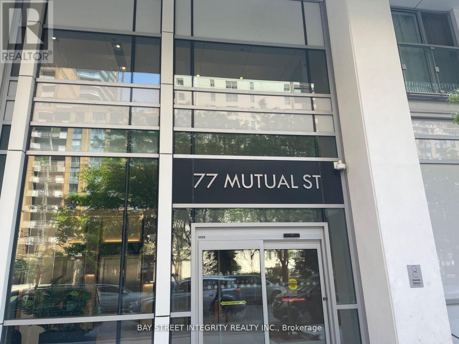 The image shows the front of a building with the address 77 Mutual St.