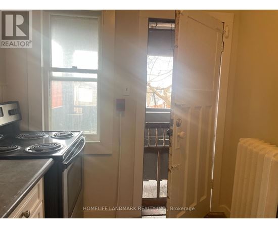 A small kitchen with a stove and a window.