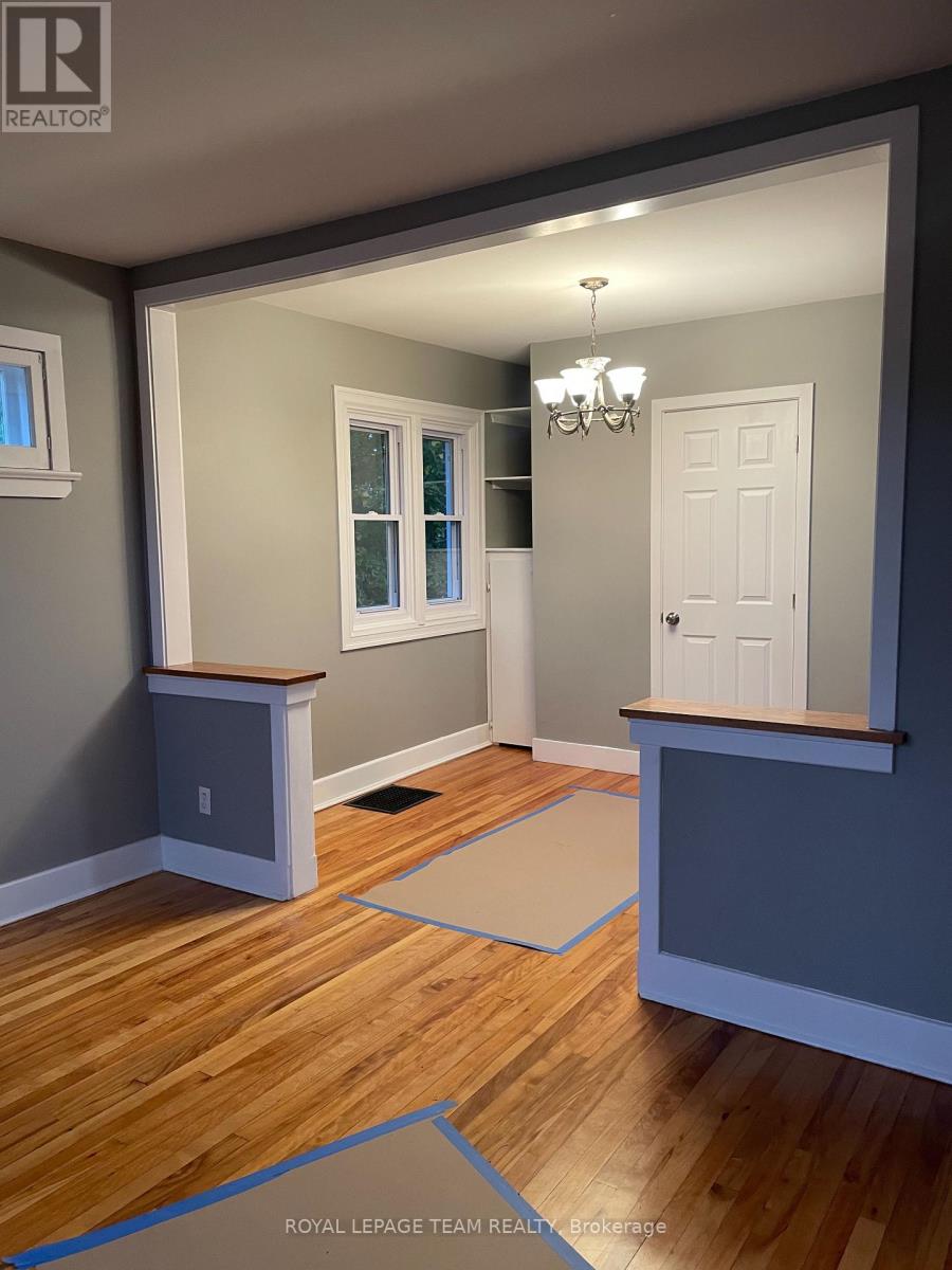 A room with a wooden floor and a chandelier.