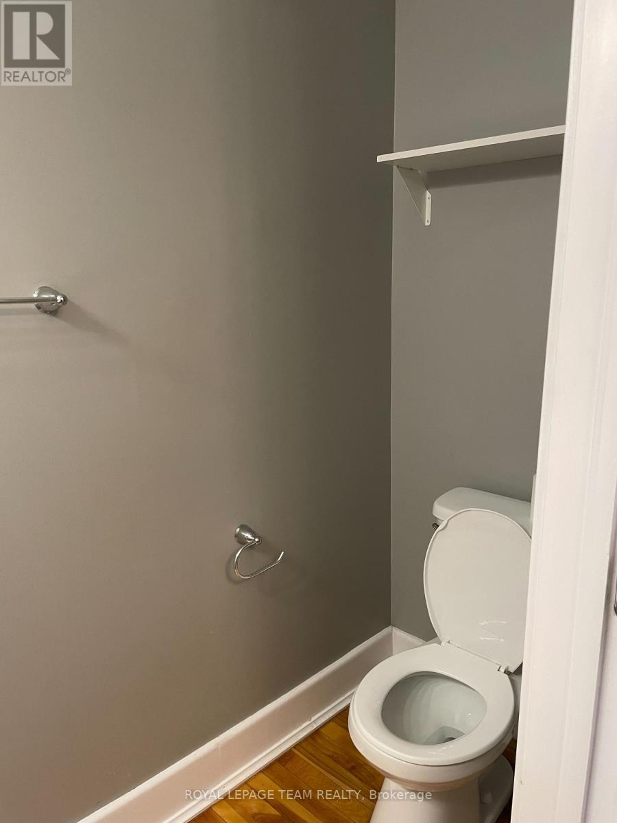 A white toilet in a small bathroom.