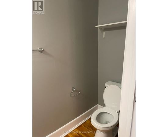 A white toilet in a small bathroom.