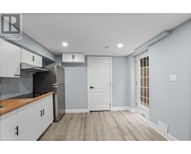 A kitchen with a white door and cabinets.