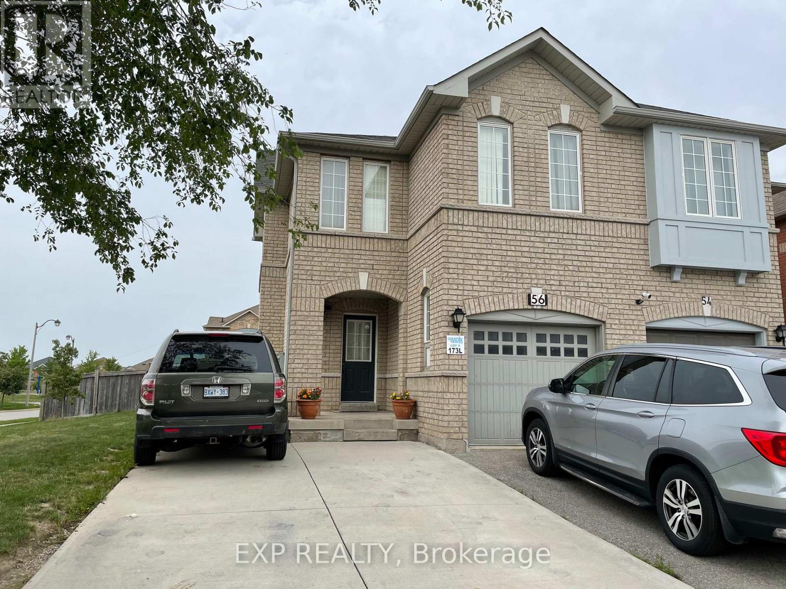 A house with a garage and a car parked in front.