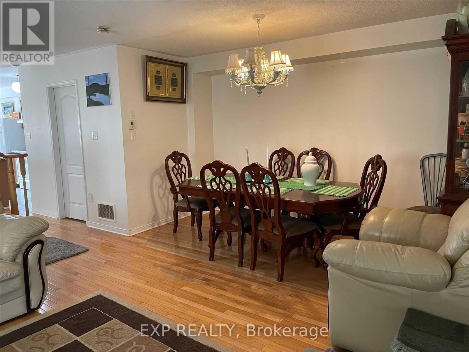 A dining room with a wooden table and chairs.
