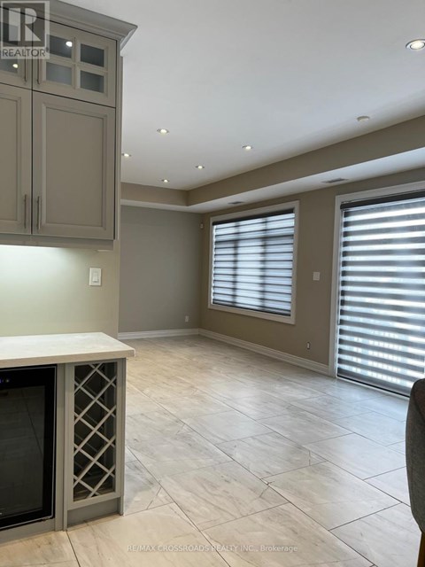A kitchen with a wine cooler and a counter top.