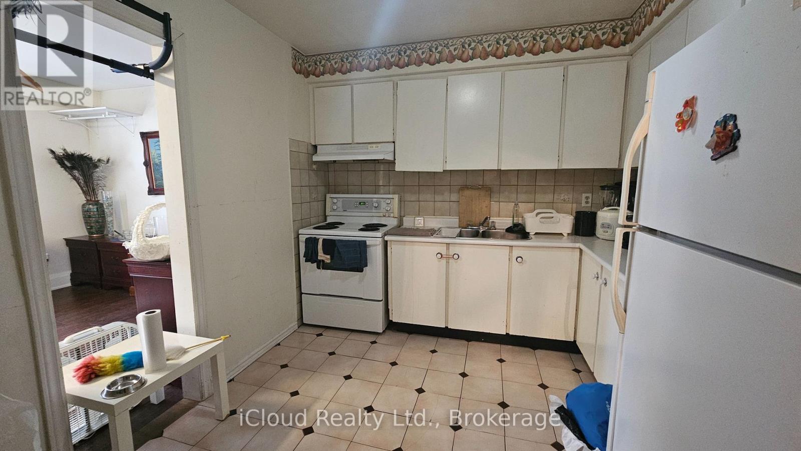 A kitchen with white appliances and cabinets.