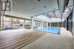 A large indoor swimming pool with a tiled floor.