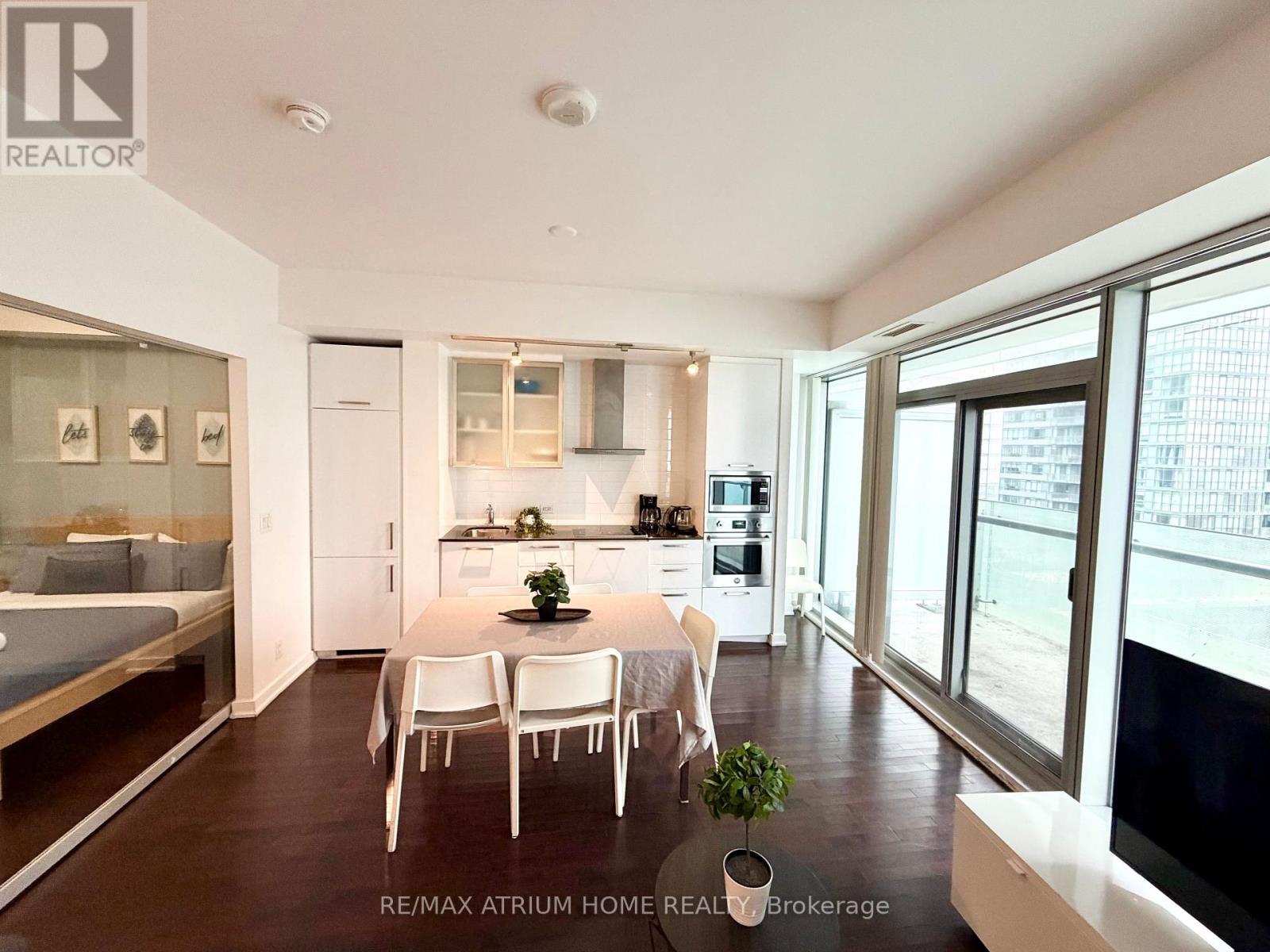 A well-lit, modern kitchen with a dining table set for four.