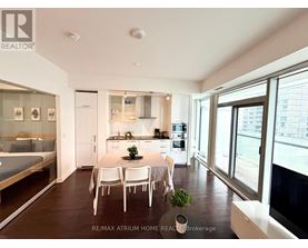 A well-lit, modern kitchen with a dining table set for four.