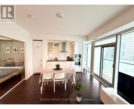 A well-lit, modern kitchen with a dining table set for four.