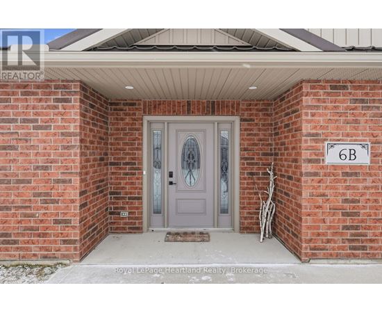 A house with a grey door and a sign that says 6B.