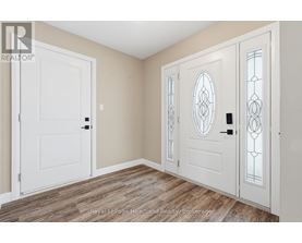 A room with a white door and a white door with a glass panel and stained glass window.