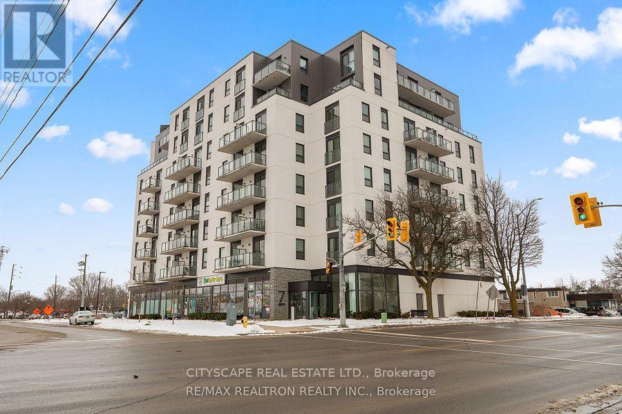 A large apartment building with a street in front of it.