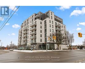 A large apartment building with a street in front of it.