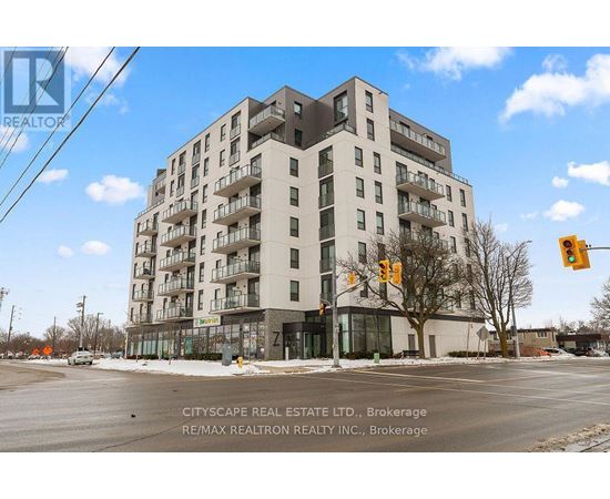 A large apartment building with a street in front of it.