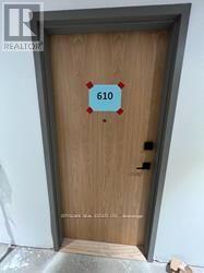 A brown door with the number 610 on it.