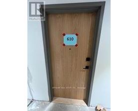 A brown door with the number 610 on it.
