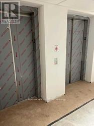 A white door with a red sign on it.