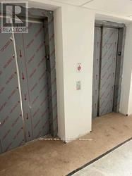 A white door with a red sign on it.