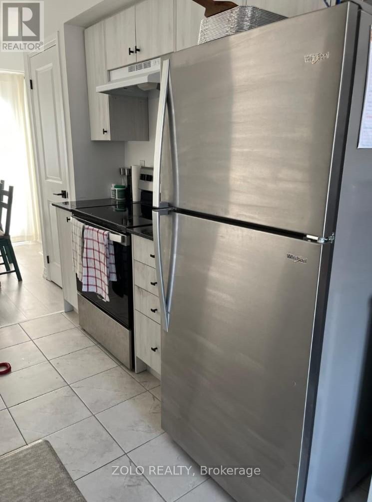 A stainless steel refrigerator in a kitchen.